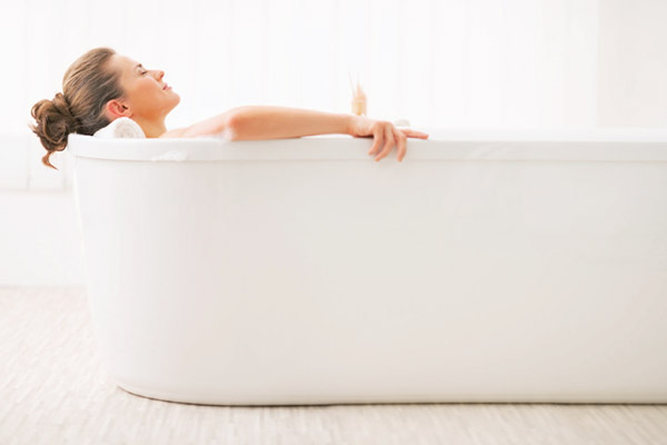 Woman soaking in a hot bath to induce fever for an immune boost