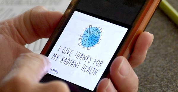 Affirmation 'I Give Thanks For My Radiant Health' on cell phone.